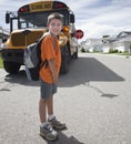 Young boy crossing in front of yellow school bus Royalty Free Stock Photo