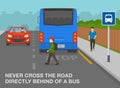Young boy crossing the road directly behind of a bus. Hidden pedestrian about to be hit by car at bus stop. Royalty Free Stock Photo