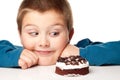 Young boy deciding to eat a dessert