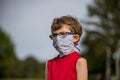 Young boy demonstrating how to properly wear a mask