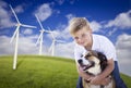 Young Boy and Dog in Wind Turbine Field Royalty Free Stock Photo