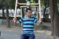 A young boy doing exercise in public park Delhi in India.