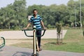 A young boy doing exercise in public park Delhi in India.