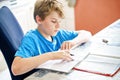 Young boy doing his homework at home. School kid learning Royalty Free Stock Photo