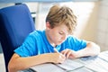 Young boy doing his homework at home. School kid learning. Royalty Free Stock Photo