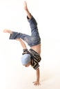 Young boy doing a one handed handstand