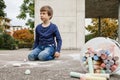 Young boy drawing on the sidewalk with chalk Royalty Free Stock Photo