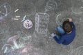 Young boy drawing on the sidewalk with chalk Royalty Free Stock Photo