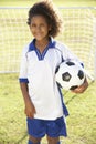 Young Boy Dressed In Soccer Kit Standing By Goal Royalty Free Stock Photo