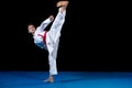 Young boy dressed in a white karate kimono with red belt. Royalty Free Stock Photo