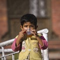 A young boy is drinking a cup of tea