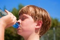 Young boy drinks water out Royalty Free Stock Photo