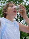 Young boy drinks water out of glass cup Royalty Free Stock Photo