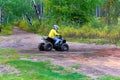 A young boy drives his quad on sandy ground Royalty Free Stock Photo