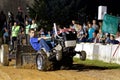 A Young Boy Drives at a Lawn Tractor Pull