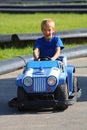 Young boy driving police car on street Royalty Free Stock Photo