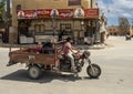 Young boy driving a three wheel cargo motorcycle transporting his family in Siwa Oasis, Egypt.