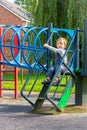 Young boy in dungarees alone on a playground Royalty Free Stock Photo