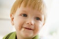 Young boy eating baby food with mess on face Royalty Free Stock Photo