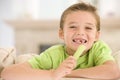 Young boy eating celery in living room Royalty Free Stock Photo