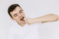 A young boy is eating a chocolate candy bar. Isolated white background Royalty Free Stock Photo