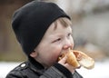 Young boy eating hotdog