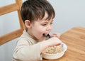 young boy eating oatmeal for breakfast Royalty Free Stock Photo