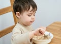 young boy eating oatmeal for breakfast Royalty Free Stock Photo