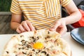 Young boy eating pizza. Teenager taking a piece of pizza with mushrooms and cheese. Still life, dinner in cafe, pizzeria. Royalty Free Stock Photo