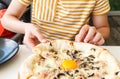 Young boy eating pizza. Teenager taking a piece of pizza with mushrooms and cheese. Still life, dinner in cafe, pizzeria. Royalty Free Stock Photo