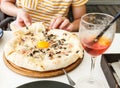 Young boy eating pizza. Teenager taking a piece of pizza with mushrooms and cheese. Still life, dinner in cafe, pizzeria. Royalty Free Stock Photo