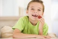 Young boy eating strawberries in living room Royalty Free Stock Photo