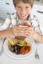 Young Boy Eating Unhealthy Fried Breakfast Royalty Free Stock Photo