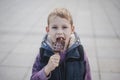 Young boy eating waffles for breakfast while looking up into the Royalty Free Stock Photo