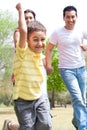 Young boy embrassing in the park with is family Royalty Free Stock Photo