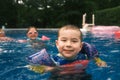 Young Boy Enjoying the Pool with Swimmies Floats Royalty Free Stock Photo