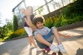 Young boy enjoying skateboarding aided by his friend Royalty Free Stock Photo