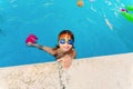 Young boy enjoying a summer dip in his swimming pool, with swimming goggles Royalty Free Stock Photo