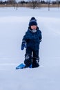 Young boy enjoying the winter while carrying a winter sled