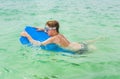 Young boy enjoys riding on the surfboard Royalty Free Stock Photo