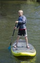 Boy Paddleboarding on a Lake