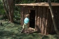 Young boy enters a play house at an outdoor garden. Royalty Free Stock Photo