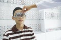 Young boy examining eyesight in optical clinic. Royalty Free Stock Photo