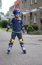 Young boy  trains with rollerblades Royalty Free Stock Photo