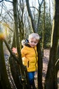 Young boy exploring and playing outdoors Royalty Free Stock Photo
