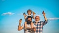 Young boy with father and grandfather enjoying together in park on blue sky background. Fathers day - grandfather Royalty Free Stock Photo