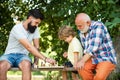Young boy with father and grandfather enjoying together in park. Generations men. Boy with father and grandfather Royalty Free Stock Photo