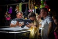 A young boy and father shooting with airsoft automatic weapon at a fair.