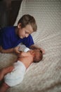 Boy feeding newborn baby with bottle of milk Royalty Free Stock Photo