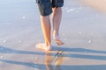 Young boy feet on summer beach sand, summer time concept. feet walking in the sand by the sea.close-up Royalty Free Stock Photo